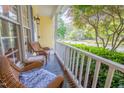 Cozy front porch with wicker chairs and a view of the beautifully landscaped yard at 5417 Harrington Grove Dr, Raleigh, NC 27613