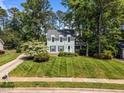 Charming two-story home with light-green siding, dormer windows, dark shutters, and a well-manicured lawn at 6420 Dresden Ln, Raleigh, NC 27612