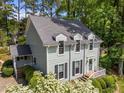 The home's exterior shows a light-green color, dormer windows, and lovely landscaping at 6420 Dresden Ln, Raleigh, NC 27612