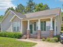 Charming single-story home with a well-manicured lawn and inviting porch at 649 Flaherty Ave, Wake Forest, NC 27587