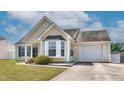 View of a charming single-story home with an attached one car garage and an established lawn at 6921 Peppermill Way, Rocky Mount, NC 27804
