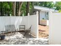 Enclosed patio area with white fencing and comfortable seating, creating a cozy outdoor space at 7177 Sandy Creek Dr, Raleigh, NC 27615
