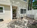 Private patio with stylish pavers and black metal furniture, perfect for outdoor relaxation at 7177 Sandy Creek Dr, Raleigh, NC 27615