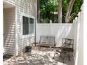 Charming patio with stylish pavers and black metal furniture, ideal for outdoor enjoyment at 7177 Sandy Creek Dr, Raleigh, NC 27615