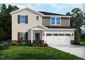 Charming two-story home with a two-car garage, manicured lawn, and tasteful landscaping at 749 Deschutes Dr, Garner, NC 27529