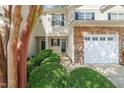 Front of townhome featuring well-maintained landscaping and an attached garage at 8253 Martello Ln, Raleigh, NC 27613