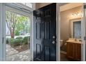 Foyer featuring a half bath off the entryway with wood-look flooring at 8253 Martello Ln, Raleigh, NC 27613