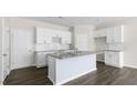 Bright eat-in kitchen features an island with countertop seating and modern stainless steel appliances at 827 Old Tarboro Rd, Wendell, NC 27591