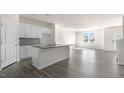Open floor plan showcasing the kitchen with white cabinets, island, and wood floors at 828 Old Tarboro Rd, Wendell, NC 27591