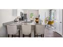 A contemporary kitchen with stone countertops, breakfast bar, stainless appliances, and eating area at 8536 Beckett Chase Way, Raleigh, NC 27616