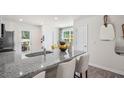 Bright kitchen with a granite island countertop, stainless steel appliances and modern cabinetry, perfect for cooking and entertaining at 8548 Beckett Chase Way, Raleigh, NC 27616