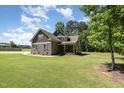 Charming two-story home with stone and shingle siding on a well-maintained lawn at 91 Carsons Creek Trl, Wendell, NC 27591
