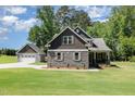Beautiful two-story home featuring a stone and shingle exterior with a detached two car garage at 91 Carsons Creek Trl, Wendell, NC 27591