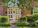 Charming brick townhouse featuring a quaint front entrance and well-maintained landscaping at 945 St Marys St, Raleigh, NC 27605