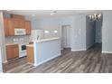 Open concept kitchen with stainless steel appliances and breakfast bar at 958 Shining Wire Way, Morrisville, NC 27560