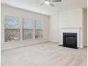 Spacious living room with neutral carpet, fireplace and large windows with blinds at 1009 Magnolia Leaf Ct, Apex, NC 27502