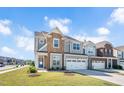 Charming two-story home boasts stone accents, a two-car garage, and a well-manicured lawn at 101 Rostova Way, Holly Springs, NC 27540