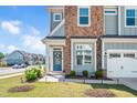 Charming entry door with wreath, stone facade, landscaping and two car garage at 101 Rostova Way, Holly Springs, NC 27540