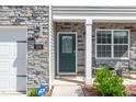 Close-up of the front door with stone veneer, house number, and welcoming entrance at 103 Norris Creek Dr, Clayton, NC 27527