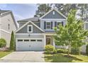 Inviting two-story home with a gray exterior, well-manicured lawn, and an attached two-car garage at 120 Chapel Run Way, Chapel Hill, NC 27517