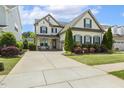 Beautiful two-story home featuring a long driveway and a well maintained lawn at 121 Martingale Dr, Holly Springs, NC 27540