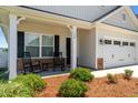 Inviting front porch with rocking chairs and stone accents, perfect for relaxing outdoors at 124 Boomer St, Benson, NC 27504