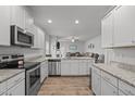 Modern kitchen with stainless steel appliances, granite countertops, and ample cabinet space at 124 Boomer St, Benson, NC 27504