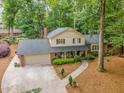 Beautiful aerial view of home with large yard, driveway and surrounded by mature trees at 125 Amesbury Ln, Cary, NC 27511