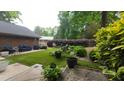 Back yard featuring a well-maintained artificial lawn and a comfortable outdoor seating area at 125 Amesbury Ln, Cary, NC 27511