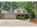 Spacious home with attached garage and long driveway nestled in a wooded setting at 125 Amesbury Ln, Cary, NC 27511