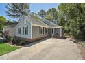 Charming one-story home with blue siding, shutters, a well-maintained lawn and a driveway at 1304 Greenside Dr, Raleigh, NC 27609