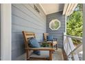 Inviting front porch with seating, blue pillows, and view of the greenery at 1304 Greenside Dr, Raleigh, NC 27609