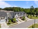 A beautiful neighborhood featuring townhomes, manicured lawns, and tree-lined streets at 1394 Southpoint Trl, Durham, NC 27713