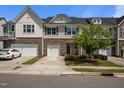 Inviting townhome with a single-car garage, stone accents, and a nicely landscaped front yard at 1394 Southpoint Trl, Durham, NC 27713