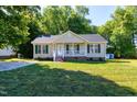 Inviting home boasts a classic design, green shutters, manicured lawn, and a glimpse of the driveway at 1443 Smokey Mountain Dr, Zebulon, NC 27597