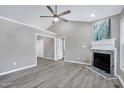 Bright living room with vaulted ceiling, neutral walls, a fireplace, and modern ceiling fan at 1443 Smokey Mountain Dr, Zebulon, NC 27597