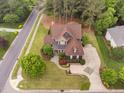 Aerial view of a large home with mature trees, a long driveway, and well-kept landscaping at 1508 Samuel Wait Ln, Wake Forest, NC 27587