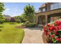Beautiful front yard with stone walkway, bench, and mature landscaping leading to the front door at 1508 Samuel Wait Ln, Wake Forest, NC 27587