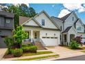 Charming home with white siding, well-manicured lawn, and a welcoming two-car garage at 151 Monteith Dr, Chapel Hill, NC 27516
