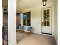Inviting covered front porch features chairs, a wreath, and plenty of natural light at 151 Monteith Dr, Chapel Hill, NC 27516