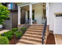 Cozy brick front porch with seating and charming details, perfect for relaxing outdoors at 151 Monteith Dr, Chapel Hill, NC 27516