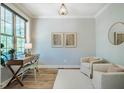 Bright office with large windows, desk, and two chairs at 151 Monteith Dr, Chapel Hill, NC 27516