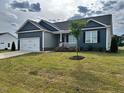Attractive one-story home featuring a well-maintained lawn and a quaint covered porch at 152 Springtooth Dr, Zebulon, NC 27597