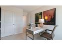 Home office space with a neutral color scheme, desk, chair, and natural lighting at 177 Holton St, Smithfield, NC 27577