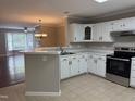 Bright kitchen with white cabinets and countertops, stainless steel appliances, and tile flooring at 210 Standish Dr Dr, Chapel Hill, NC 27517