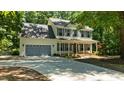 Inviting two-story home with blue shutters, a welcoming front porch, and a spacious driveway at 25 Ballinger Dr, Youngsville, NC 27596