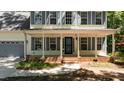 Charming front porch with classic columns and brick accents, a perfect spot for relaxing at 25 Ballinger Dr, Youngsville, NC 27596