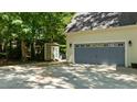 Spacious two-car garage with a shed in the backyard, providing ample storage at 25 Ballinger Dr, Youngsville, NC 27596