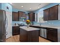 Modern kitchen featuring stainless steel appliances, an island, and countertops with light blue walls at 25 Gallery Park Dr, Franklinton, NC 27525
