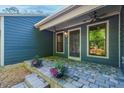 Cozy porch with brick flooring, ceiling fans, and decorative planters with beautiful flowers at 2511 Bexley Ave, Durham, NC 27707